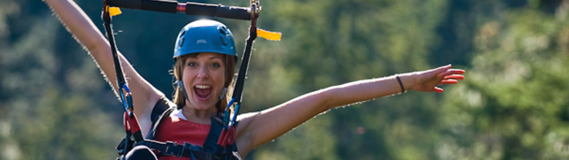 zipline woman happy helmet