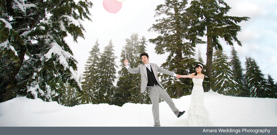 Wedding couple in the snow with pink balloon at Grouse Mountain